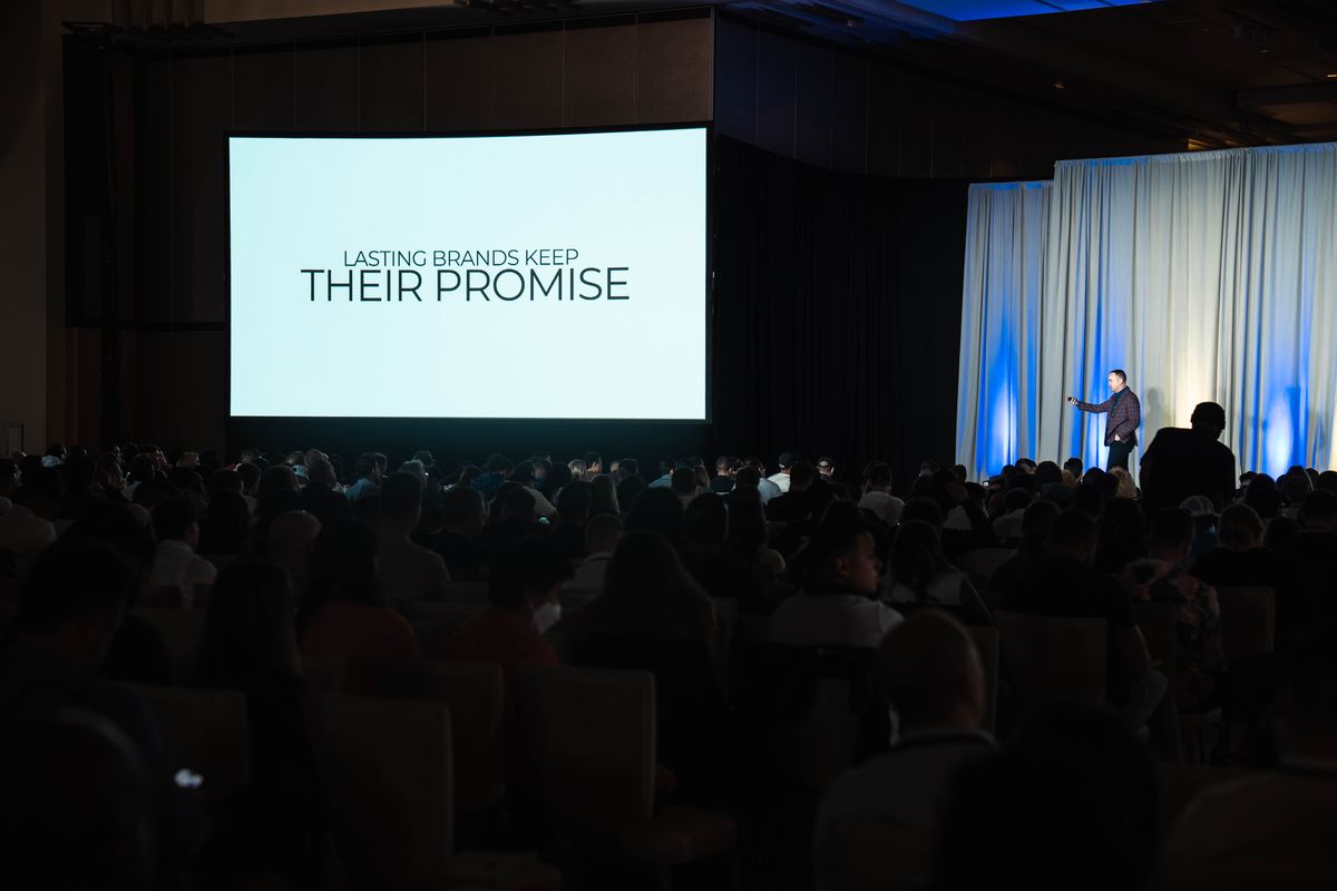Brandon presenting to a full ballroom